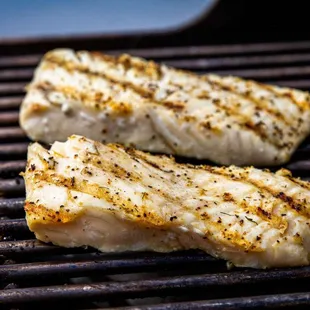 two pieces of fish on a grill
