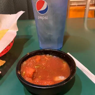 a bowl of soup and a drink