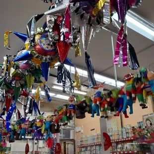a variety of toys hanging from the ceiling