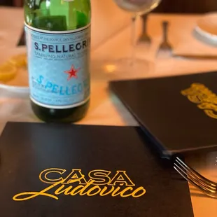 a glass of wine and a menu