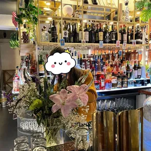 a woman behind a bar with a cloud above her head