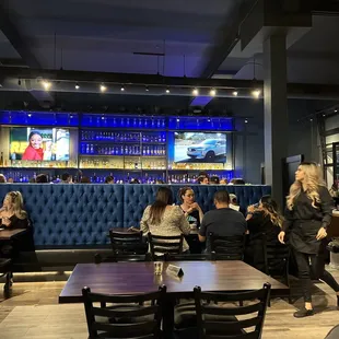 people sitting at tables in a restaurant