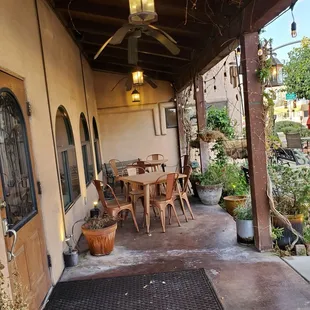 a patio with tables and chairs