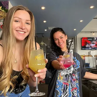 two women holding up their drinks