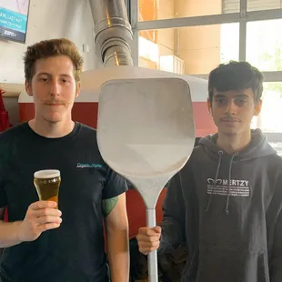 two men holding a paddle