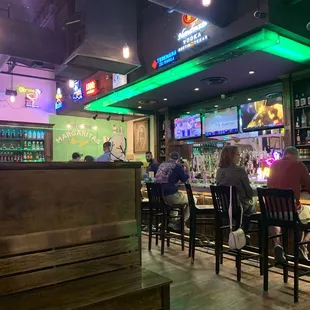 people sitting at tables in a bar