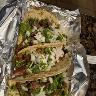 two tacos with meat and onions