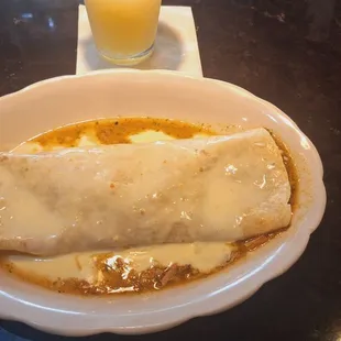 Pork (carnitas) burrito, with plenty of queso and Chili Verde, out of this world, by special order, for an extra buck.