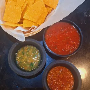The standard house salsa, a delicious green salsa and a spiced up concoction, made in-house