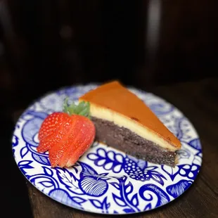 a piece of cake and a strawberry