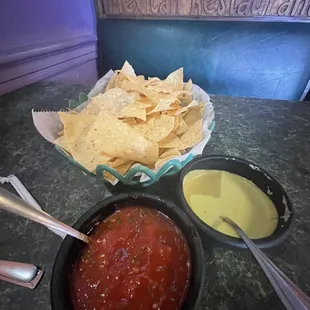 Chips &amp; salsas. Red is very  flavor influenced. Green is was also good. Served room temp/cool.