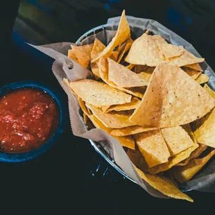 a basket of chips and salsa
