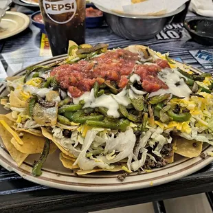 Taco Salad over chips with grilled veggies and queso ..