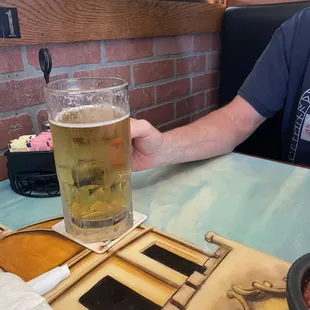 a man holding a glass of beer