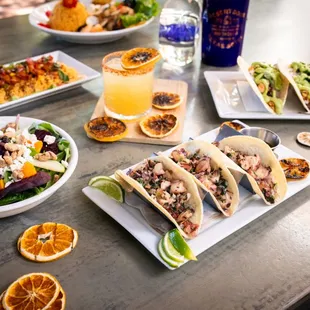 a table full of tacos and drinks