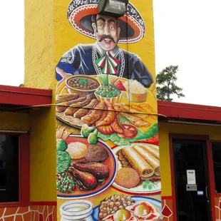 a mural on the side of a mexican restaurant