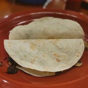 two tortillas on a red plate