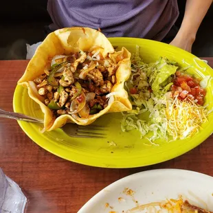 a plate of tacos and a bowl of salad