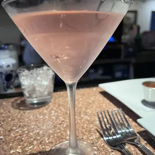 a close up of a martini glass on a table