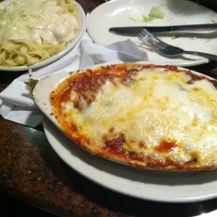 Parmesan chicken ( it&apos;s somewhere in there under the cheese) with fettuccine Alfredo