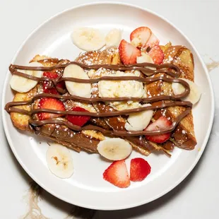 Nutella French Toast
Double dipped golden brown French toast with Nutella drizzle and topped with strawberry and banana.