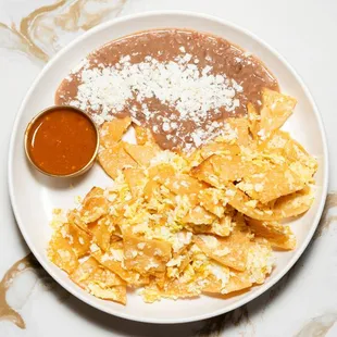 Migas & Eggs
Fried corn tortilla scrambled with eggs, refried beans and our house-made sauce.