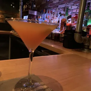 a martini sitting on a bar counter