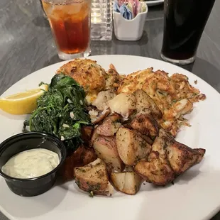 Two 8oz crab cakes, sautéed spinach and roasted potatoes.