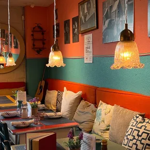 a dining room with orange and green walls