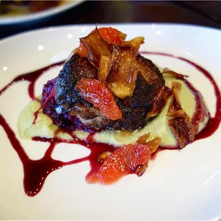 Stuffed Lamb Belly with Mojo Rojo, Burnt Onion Yogurt & Pumpkin Seeds