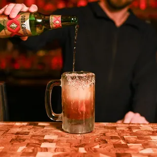 a bartender pouring a drink