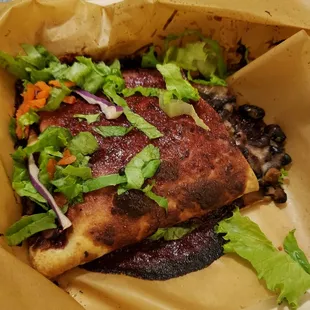 a sandwich with lettuce and black beans