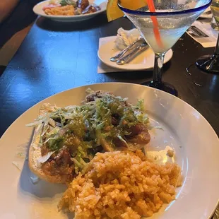 a plate of mexican food and a martini