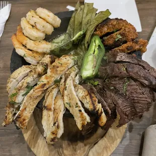 Molcajete with shrimp, chorizo, steak, and chicken.