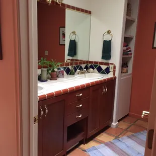 Inca Dove private bathroom with double sink vanity done in Mexican tile across from the room).