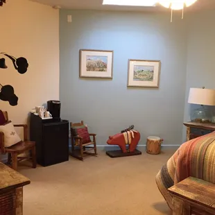 Inca Dove Room seating and mini fridge with coffee maker.