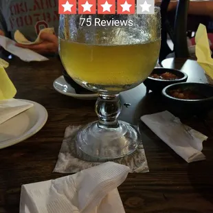 a man sitting at a table with a glass of beer