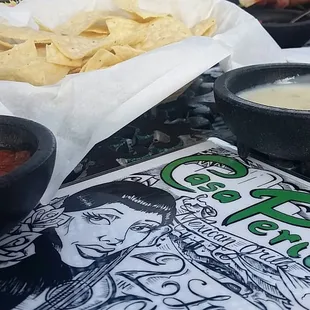 Tortillas,  salsa and queso for each table.