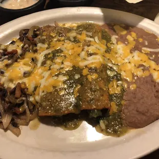Spinach enchiladas with green sauce, grilled veggies and refried beans
