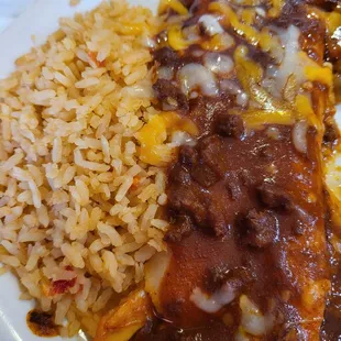 Bland rice and Hormel chili sauce cheese enchiladas