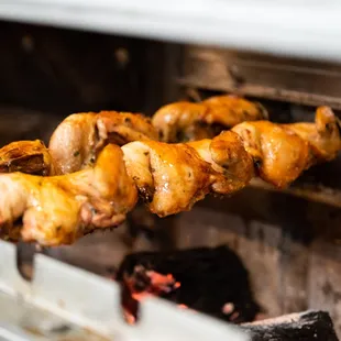 a bunch of chicken on a skewer