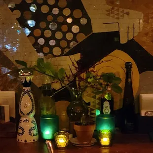 a wooden table with vases and candles