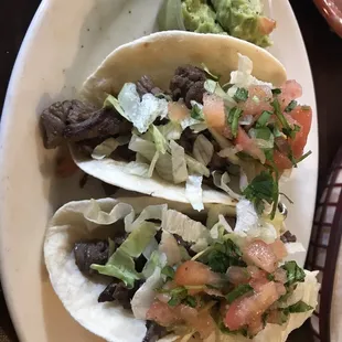 a plate of tacos and guacamole