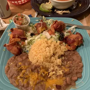 a plate of beans, rice, and bacon