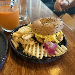 Bagel with bacon egg and potatoes