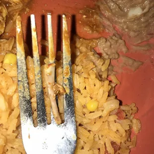 a fork stuck into a plate of food