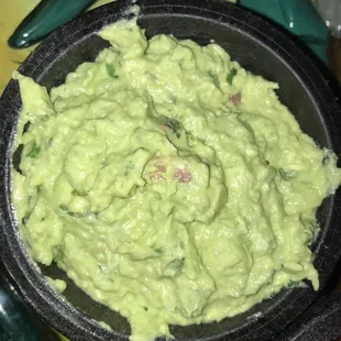 a bowl of guacamole on a table
