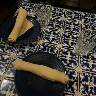 a place setting with blue plates and napkins