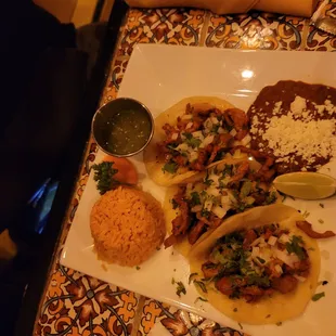 a plate of tacos and rice