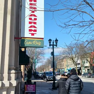 two people walking down the sidewalk